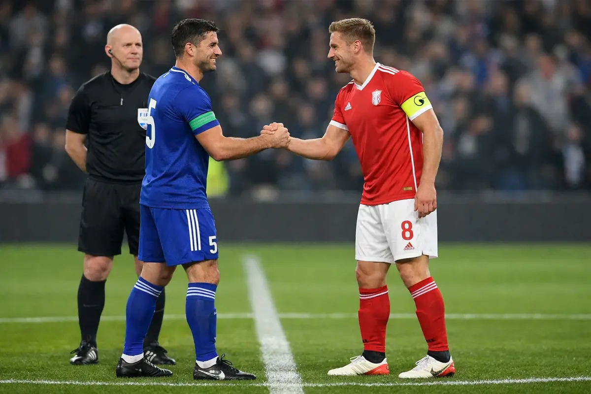 Twee voetbalteams schudden handen na afloop van wedstrijd